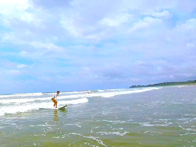 Woman surfing in Nosara, Costa Rica.