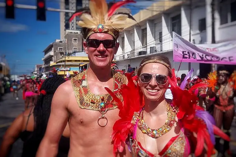 Couple in carnival dress with feathers and rhinestones.