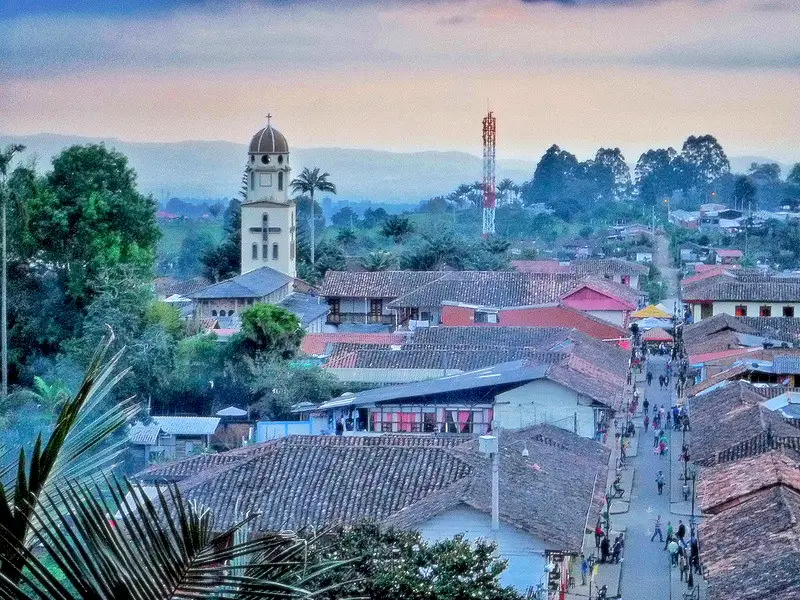 Church tower across rooftops in Salento, Colombia.