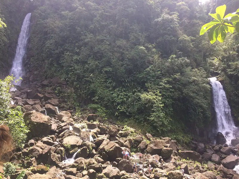 Twin waterfalls of Trafalgar Falls, Dominica. Two waterfalls falling into a sea of large rocks.