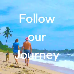 couple with dog walking on tropical beach with text "follow our journey"