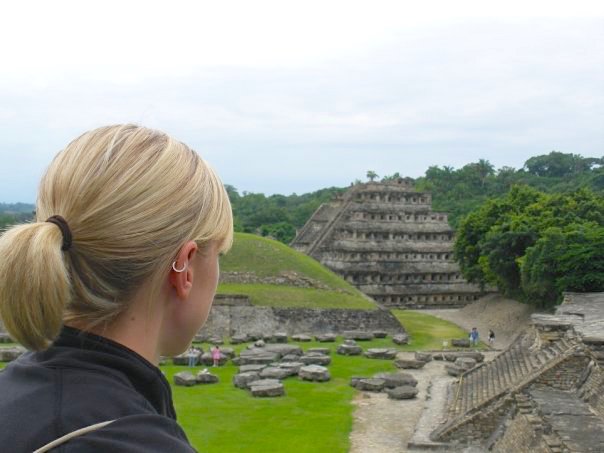 Woman looking at detailed pyramid and ruins at El Tajin, Mexico