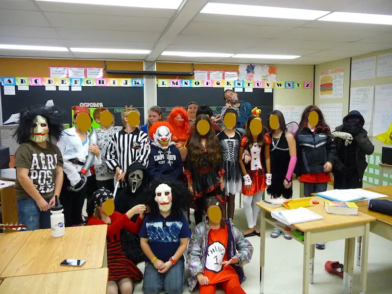 Group of students dressed up for Halloween in a classroom.