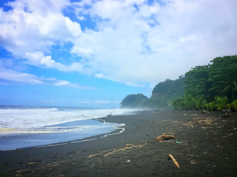 Black sand beach with big waves at Playa Hermosa, Jaco, Costa Rica