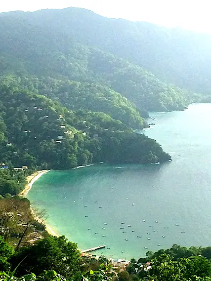 View of emerald water and dense treed hills around Charlotteville, Tobago.