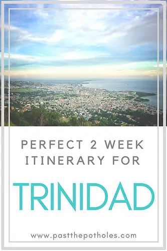 Sunset over Port of Spain and water with text: Perfect 2 week itinerary for Trinidad.