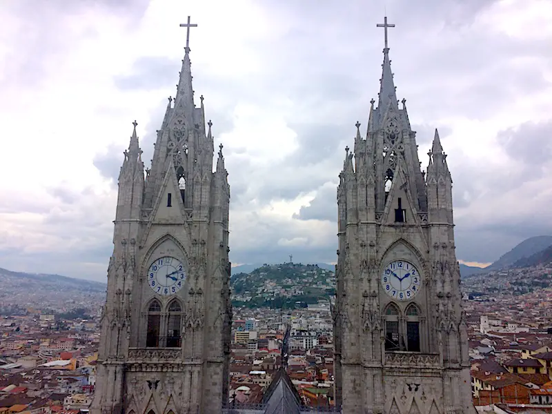 Twin towers of basilica church overlooking Quito Ecuador