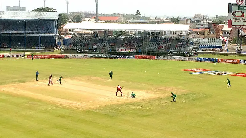 A cricket match is being played inside a stadium - sports activities in Trinidad