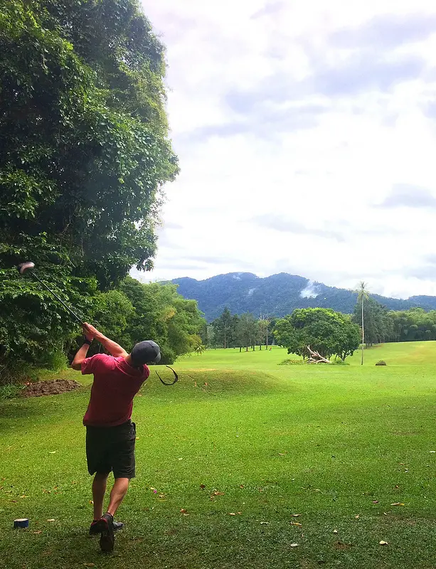 Man swinging on the tee at Chaguaramas Golf Course, Trinidad