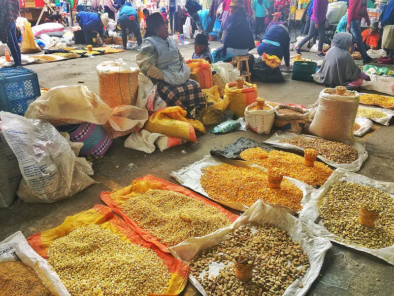 Large selection of grains laid out on the ground in a market in Ecuador.
