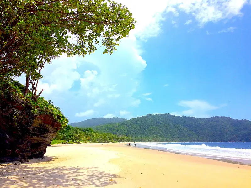 Empty golden sand on a wide sweeping bay at Las Cuevas Caribbean beach in Trinidad