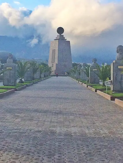 Large stone monument at the end of a walkway marking the magnetic equator in Ecuador.