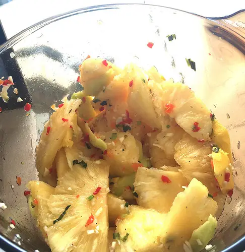 A bowl filled with pineapple and spices, called pineapple chow in Trinidad