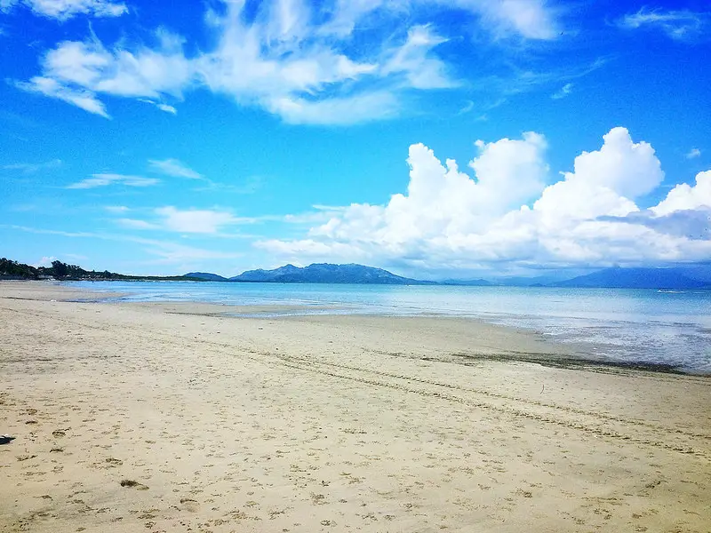 Long wide empty beach of golden sand and blue sky in Punta Chame, Panama