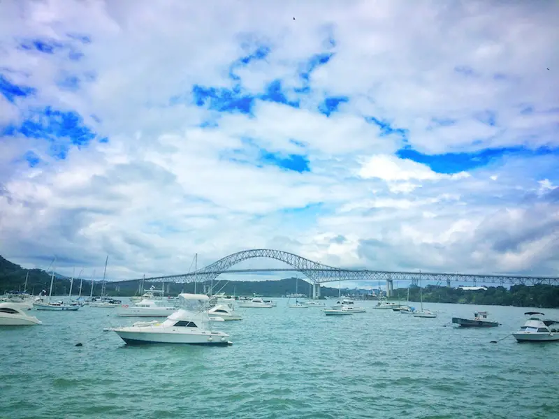 Many boats in start of Panama Canal with Bridge of Americas in the background, Panama City, Panama.