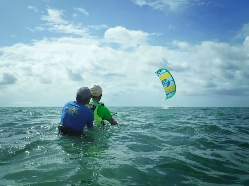 Student and instructor in Caribbean Sea learning to kitesurf in Tobago.