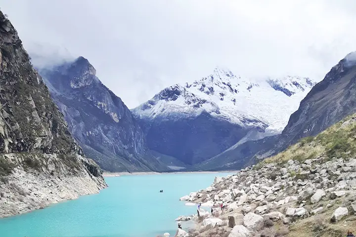 Bright turquoise glacier lake, Laguna Paron, backed by snow-capped Andes mountains in Huaraz, Peru.