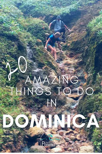 Couple climbing down a rocky cliff to Boiling Lake, Dominica.