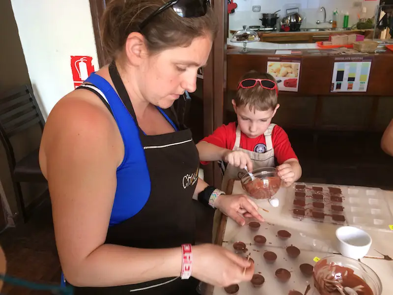 Woman and boy making chocolates at the Chocmuseum workshop in Lima.