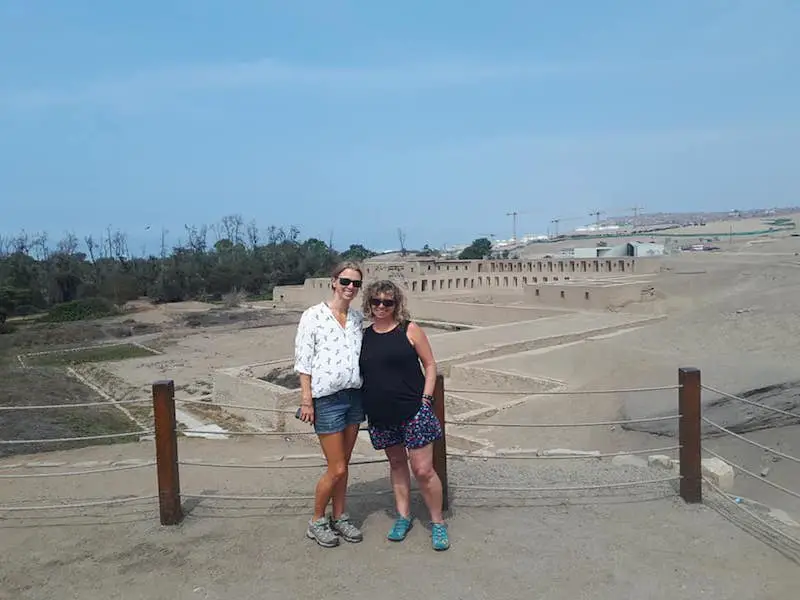 Two woman standing in front of the ruins at Pachacamac near Lima, Peru.