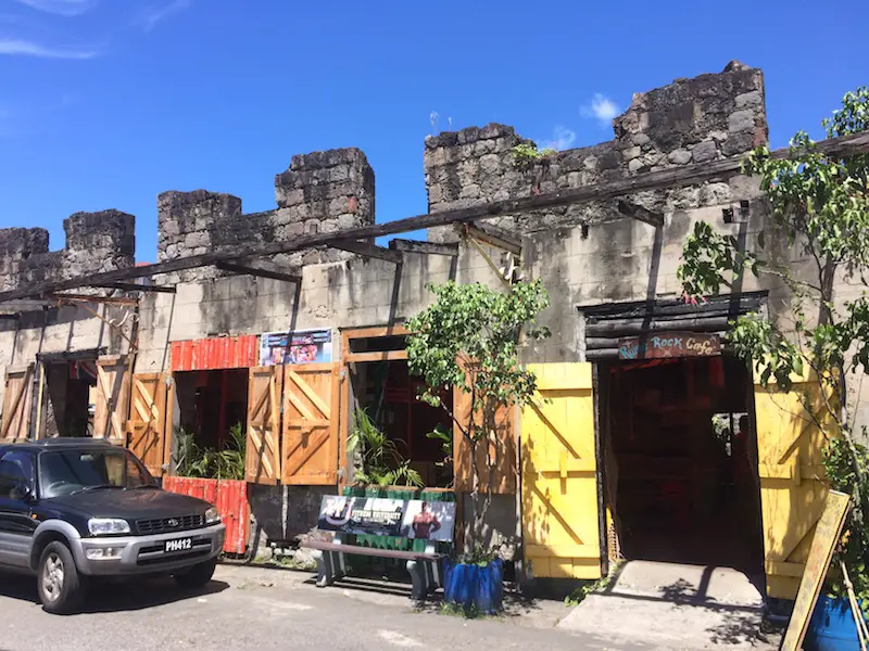 Colourful, derelict building filled with cafes in Roseau, Dominica.