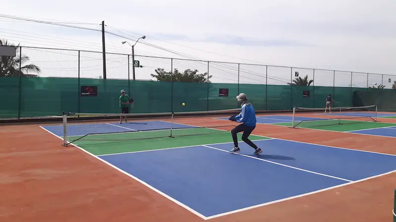 Two men playing pickle ball on an outdoor court in Ajijic, Mexico.