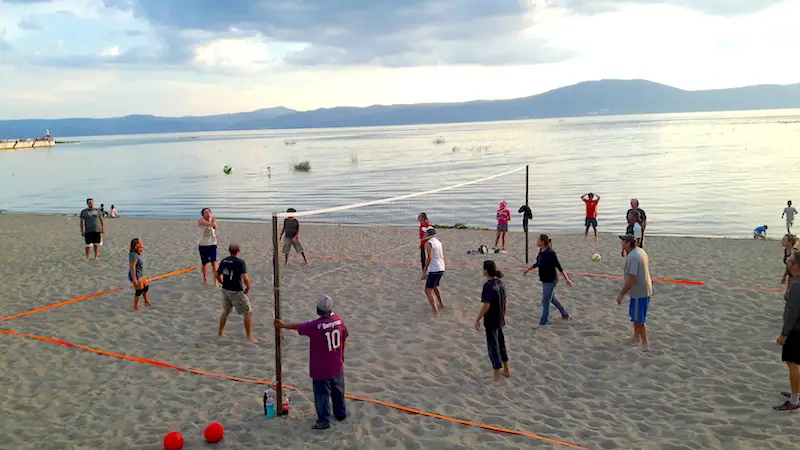 Group playing volleyball at dusk on the beach at Lake Chapala, Mexico.