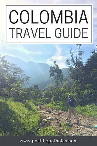 Man walking through sunny valley surrounded by mountains with text: Colombia Travel Guide