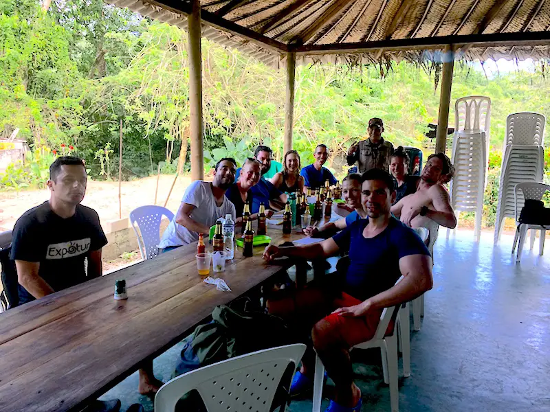 Group of hikers celebrating finishing Lost City Trek with a cold beer.