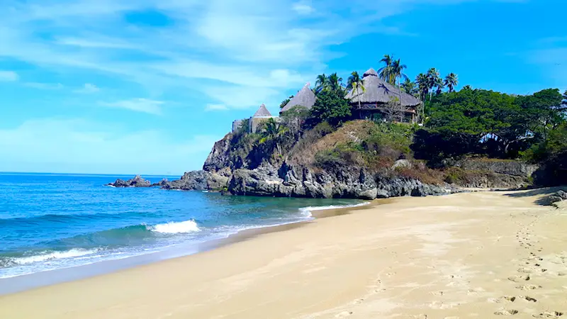 A beautiful house on a rocky outcrop overlooking the blue Pacific Ocean in San Pancho, Mexico.