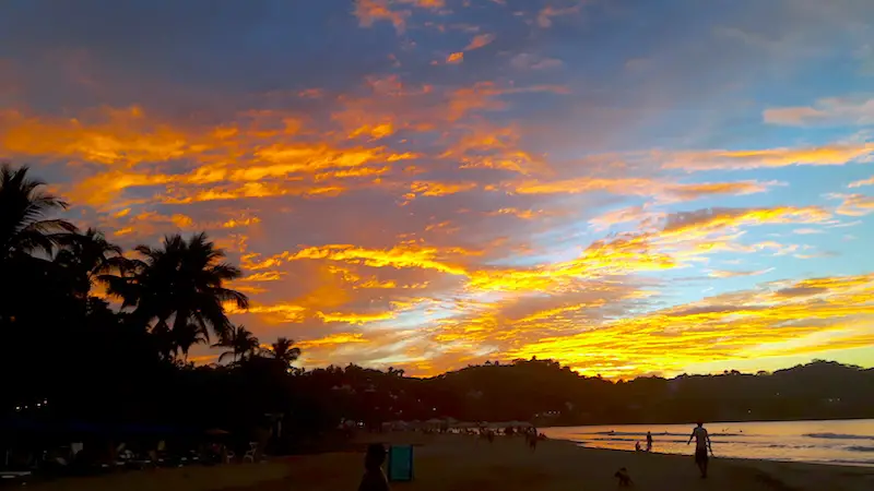 Bright oranges in the sky at the beach sunset in Sayulita, Mexico.