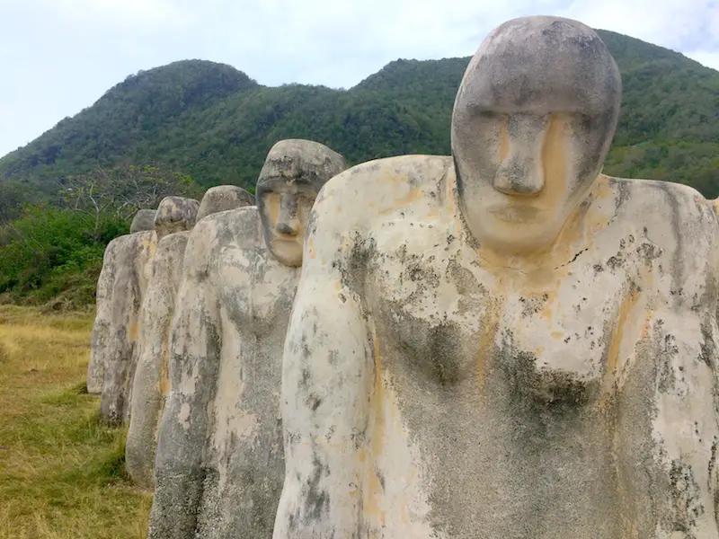 Close up of stone people at Anse Cafard Slave Memorial, Martinique