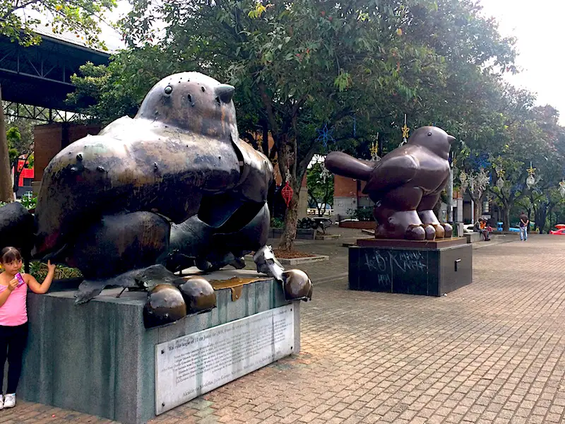 Two identical Botero sculptures, one damaged in a bomb and one replacement in Medellin, Colombia.