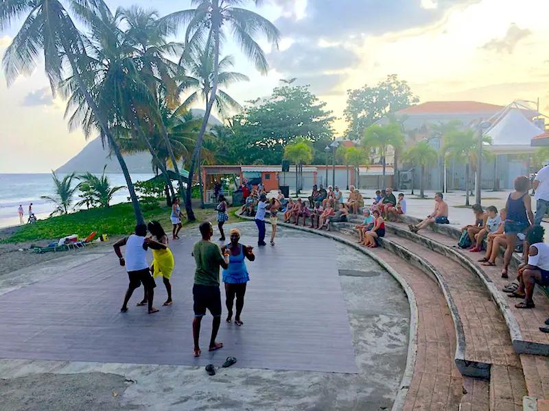 Couples dancing in a plaza in Le Diamant, Martinique.