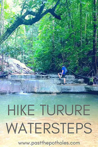 Man climbing up a series a limestone waterfalls in the jungle at Turure Watersteps, Trinidad