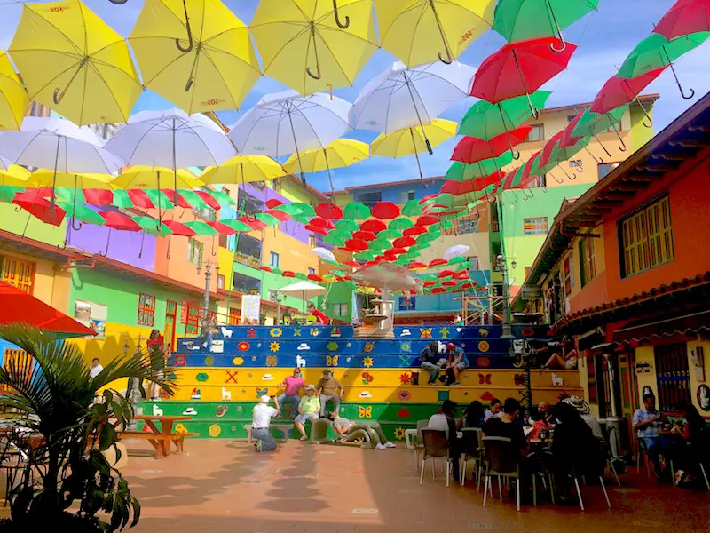 Plaza covered with brightly coloured umbrellas in Guatape, Colombia.