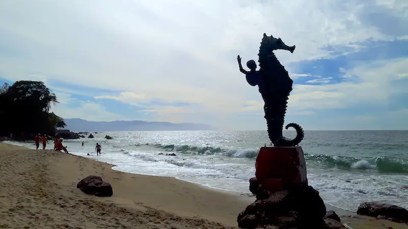 Statue of a boy on a seahorse on a beach in Puerto Vallarta, Mexico.