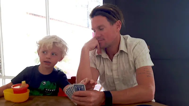 Man and boy playing cards together.