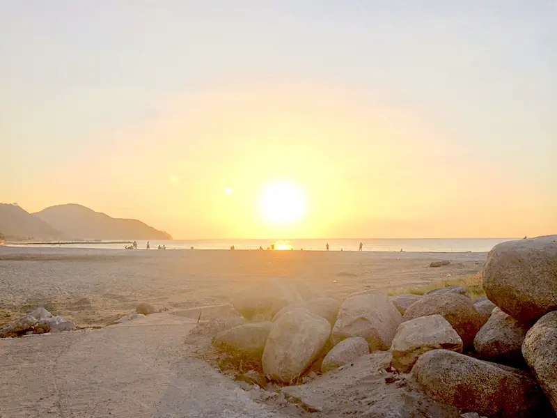 Golden sunset on the beach backed by mountains in Santa Marta, Colombia