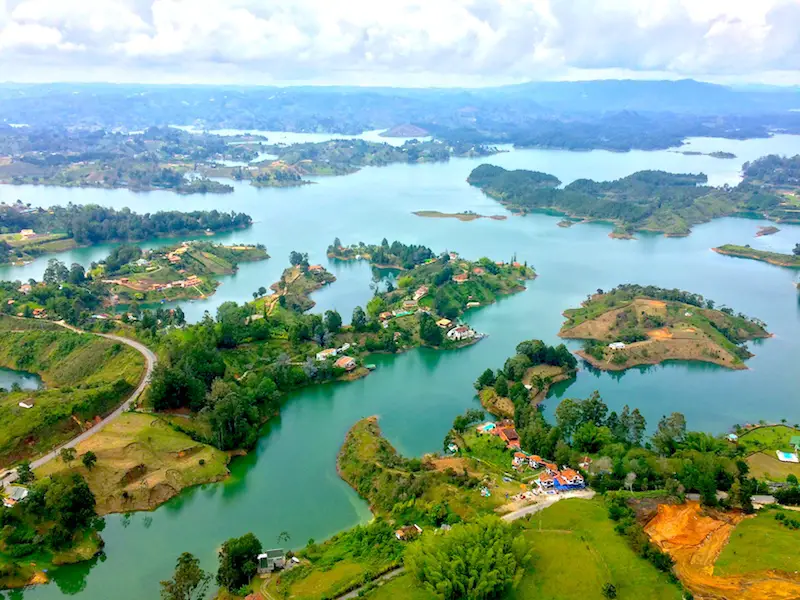 Blue lakes and green islands fill the landscape view from top of el Penon, Guatape, Colombia.