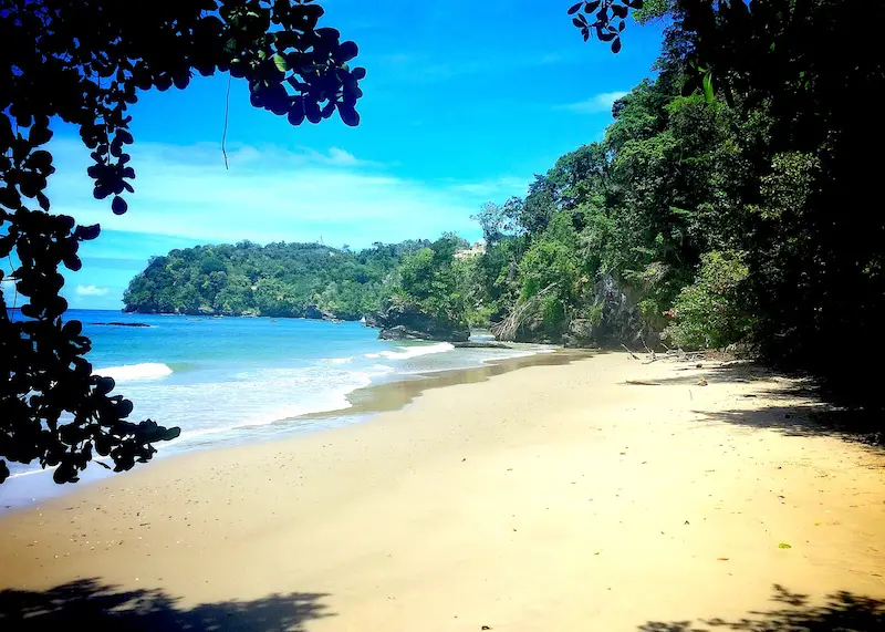 Deserted golden beach with turquoise water on North Coast of Trinidad