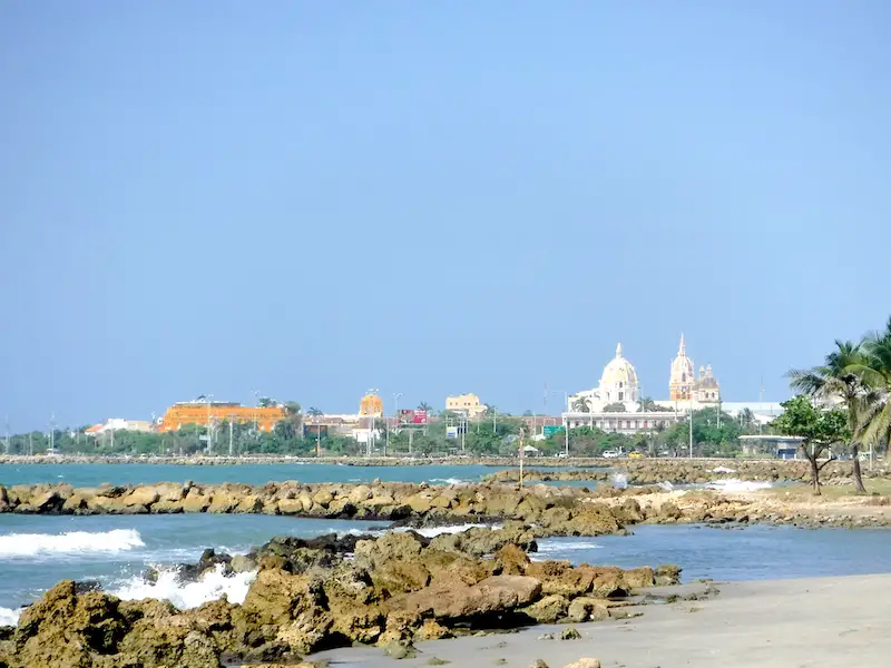 Skyline of the old city of Cartagena, Colombia from the rocky beach.