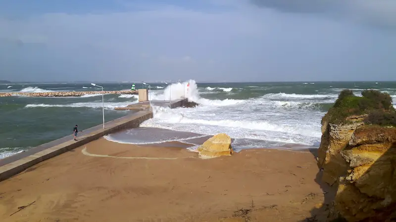 A huge wave engulfing a lighthouse in Lago, Portugal.