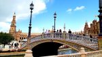 Busy bridge over a large pond in Plaza Espana in Seville Spain.