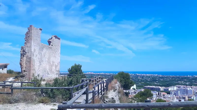 Ruins of a castle on a hill overlooking town of Oliva, Spain and the Mediterranean Sea.