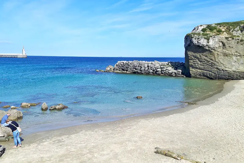Bright blue calm waters of the Mediterranean on a small beach in Tarifa, Spain.