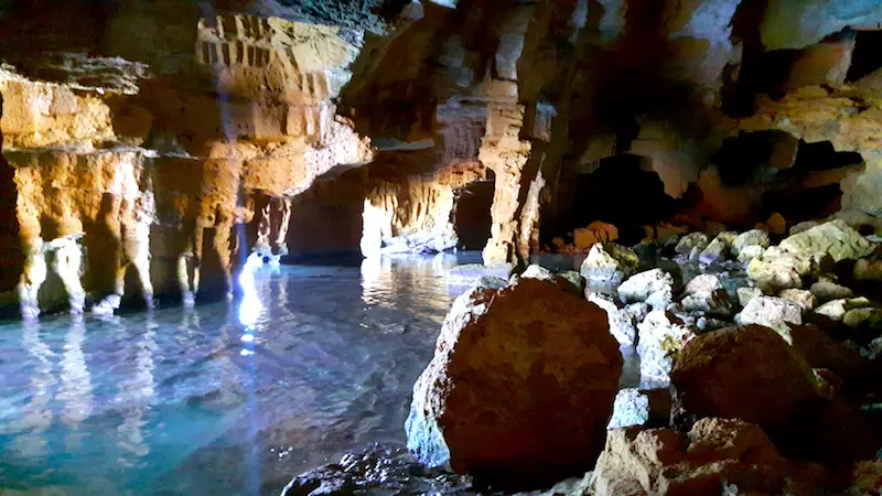 Water and rocks inside a large cave called Cova Tallada, Denia Spain.