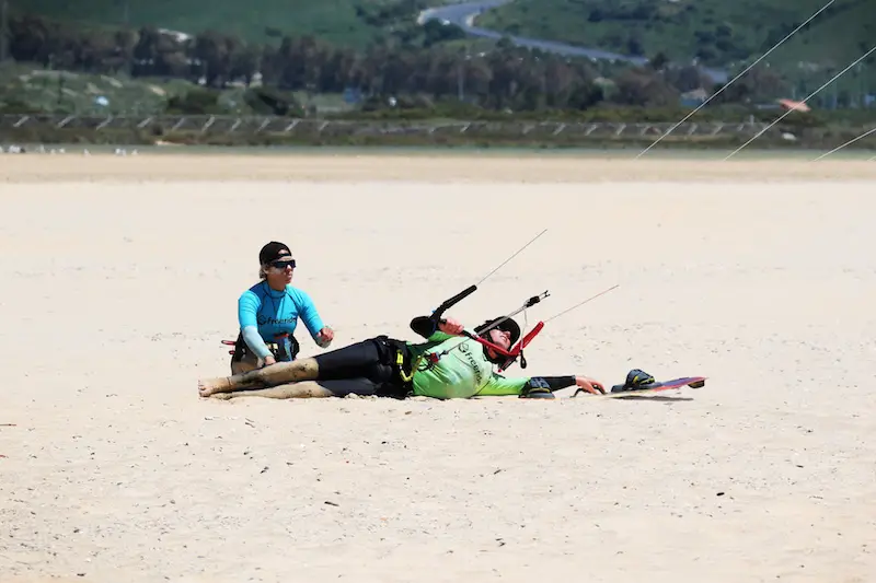 Body dragging in sand while learning to kitesurf in Tarifa, Spain.