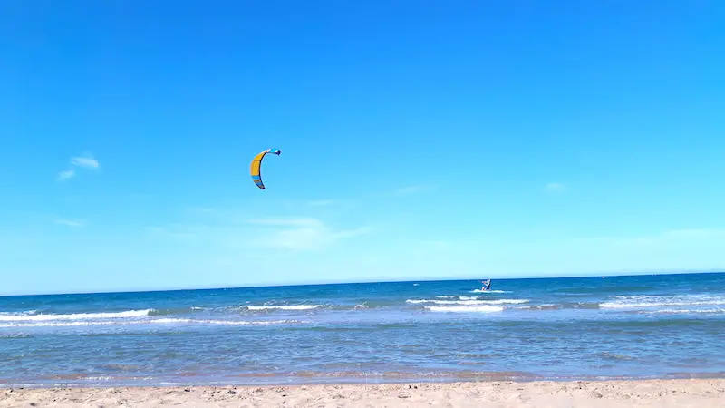 Two people kitesurfing at the beach in Oliva, Spain