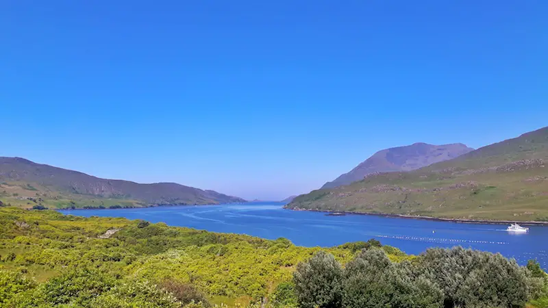 Blue narrow waterway of Killarney Fjord in Connemara National Park, Ireland.